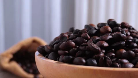 Pile of rotating roasted coffee beans in wooden bowl Stock Footage 269864802