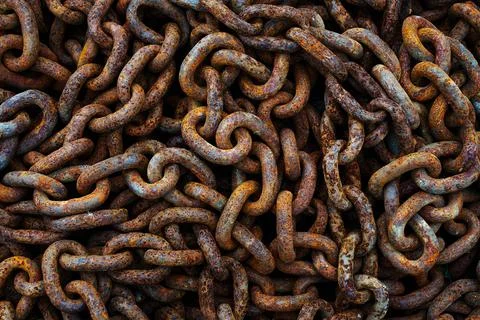 A pile of rusty chains as a dark textured background Stock Photos
