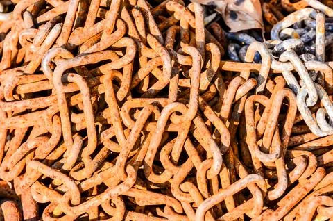 A pile of rusty chains with a lot of different shapes and sizes Stock Photos