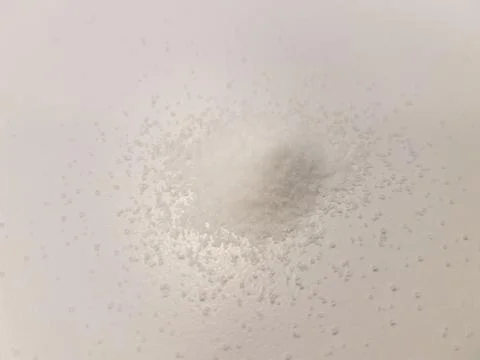 Pile of salt on white surface Stock Photos