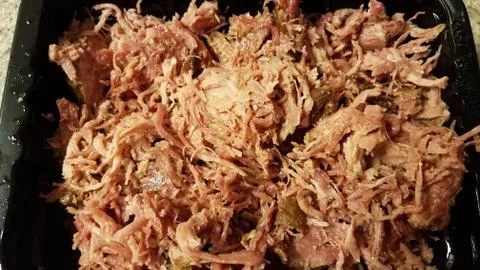 Pile of savory pulled pork meat in container Stock Photos