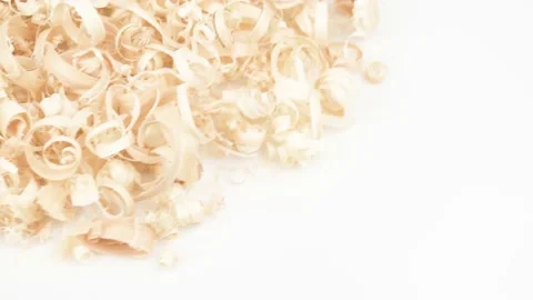 A pile of sawdust rotates in the upper left corner on a white background. Stock Footage 177857723