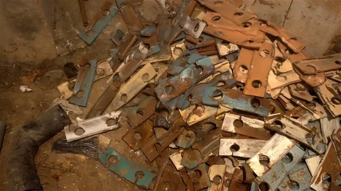 A pile of scrap metal lying on the floor in the basement Stock Footage 83303119
