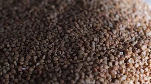 A pile of selected buckwheat groats on the table, close-up Stock-Footage 327858367