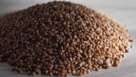 A pile of selected buckwheat groats on the table, close-up Video stock 327858388