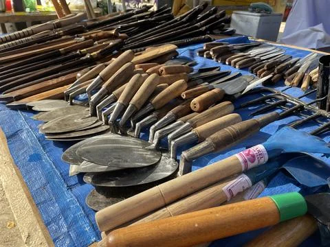 A pile of sharp tools such as knives, machetes, axes, sickles Foto stock