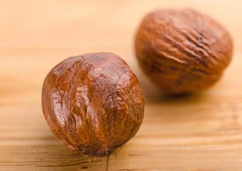 A pile of shell-less hazelnuts, isolated on textural wood background Stock Photos