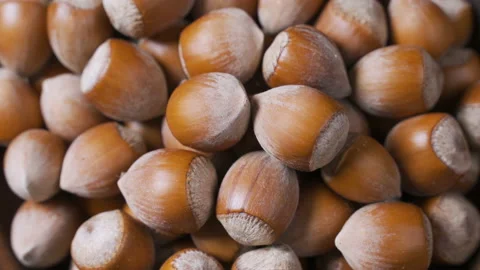 A pile of shelled hazelnuts rotating smoothly and slowly. Macro shot Stock Footage 99102632