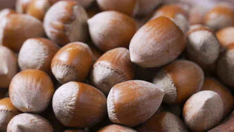 A pile of shelled hazelnuts rotating smoothly and slowly. Macro shot Stock Footage 99171249