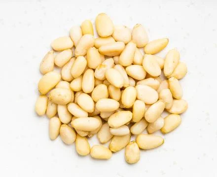 Pile of shelled pine nuts close up on gray Foto stock
