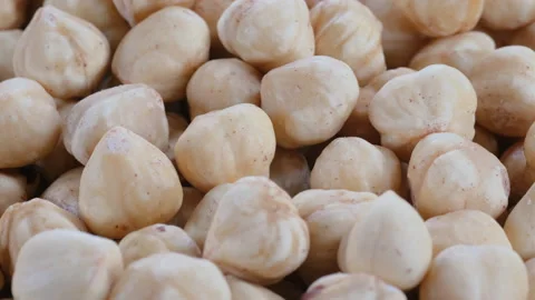 A pile of shelled white hazelnut kernels. Slider shot. Stock Footage 296537737