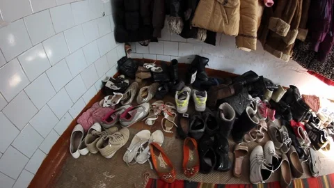 Pile Of Shoes Along Wall In Eastern European Orphanage Stock-Footage 102149831