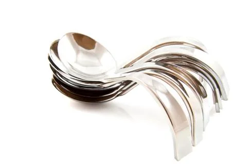 Pile of silver amuse spoons Stock Photos