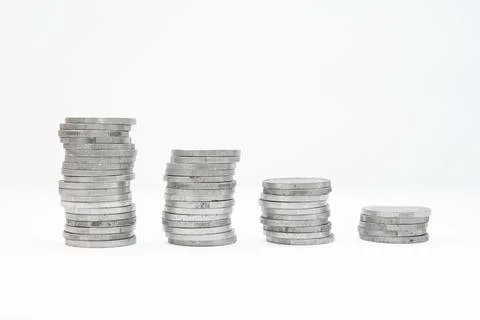 Pile of silver coins stack and growing money graph on rows of 5, 10, 15, 20.. Stock Photos
