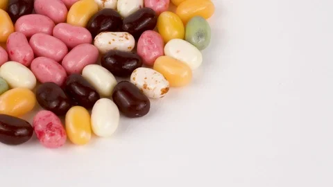 Pile of small bean shaped sugar jelly candies. Rotating on the turn table. Stock Footage 87477399