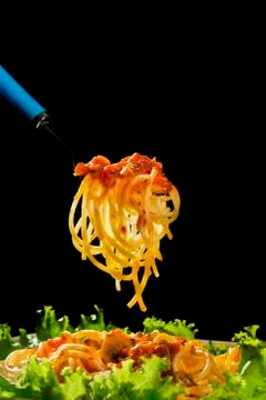 A pile of spaghetti rolled in a fork Stock Photos