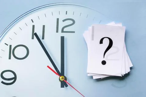 Pile of stacked question marks on a clock face Stock Photos