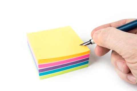 Pile of sticky note on a white background with a pen Stock Photos