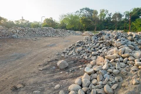 A pile of stone alongside road for constructing a stone retaining wall to pre 스톡 사진