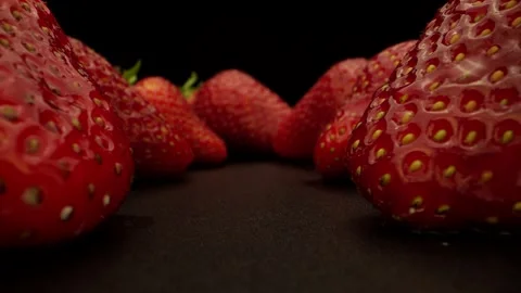 Pile of strawberries on the black background camera slowly rolling in Stock Footage 131800488