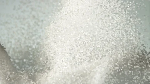 A pile of sugar rises up and falls down. Filmed is slow motion 1000 fps. Stock Footage 202140928