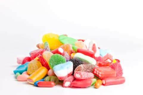 Pile of sweets on white background. Stock Photos