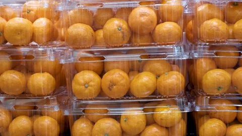 Pile of tangerines in plastic boxes in a supermarket close-up. Stock Footage 303386175