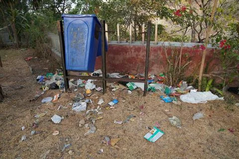 Pile of Trash lying outside a bin. Pollution environment disaster. People are Stock Photos