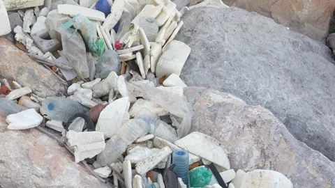 A pile of trash is on a rock Stock Footage 276343956