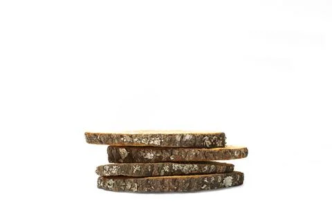 A pile of tree trunk slices on a white background Foto stock