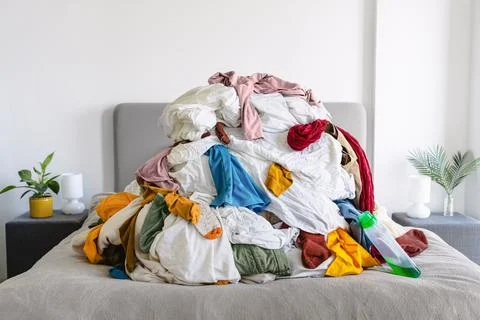 Pile of Unsorted Laundry on a Bed Foto stock