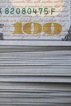 Pile of US 100 dollar banknotes on dollars background Stock Photos