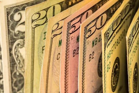 A pile of  US dollar bills on a table Stock Photos