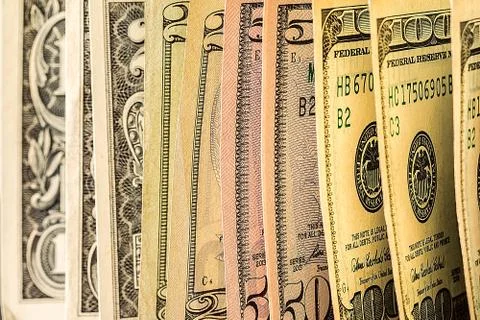 A pile of  US dollar bills on a table Stock Photos
