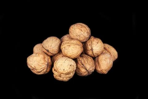 A pile of walnuts on black background Stock Photos