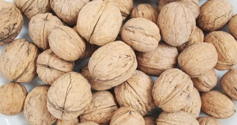 Pile of walnuts in shells, rotating, top view, close-up. Concept of satisfying Vídeos de archivo 280984037