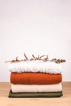 Pile of warm clothes on the table. Stock Photos