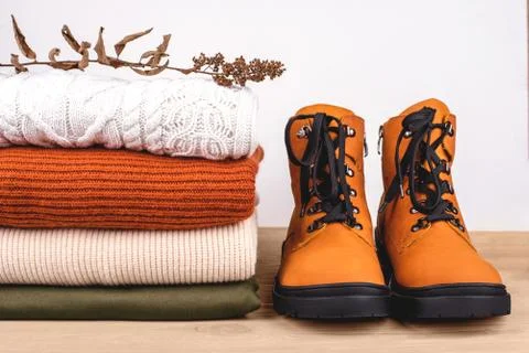 Pile of warm clothes on the table. Stock Photos