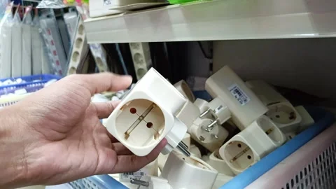 A pile of white electrical plugs and sockets are stacked in a blue plastic .. Stock-Footage 304131554