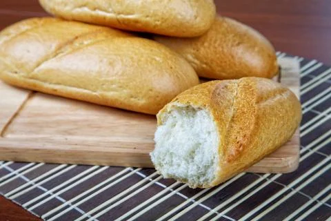 Pile of white rolls on a kitchen table Stock Photos