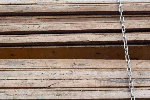 Pile of wood panels tied by a chain Stock Photos