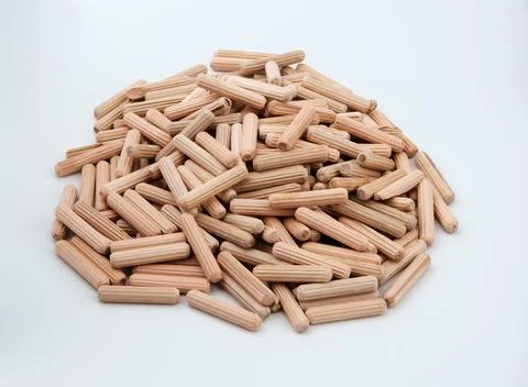 Pile of wooden furniture dowels isolated on gray. Stock Photos
