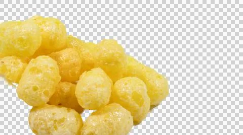 Pile of yellow corn puff snacks, crunchy textured puffed maize balls isolat. Stock Photos