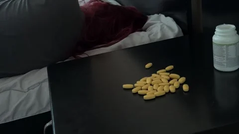 Pile of Yellow Pills on Bedside Table Stock Footage 340340981