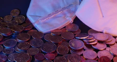 Piled up Coins next to white N 95 Protective Face Masks. Health and Economy. Stock Footage 147942971
