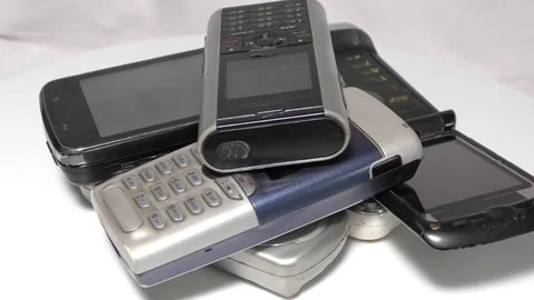Piled up old mobile phones moving in circular motion Stock Footage 111887850
