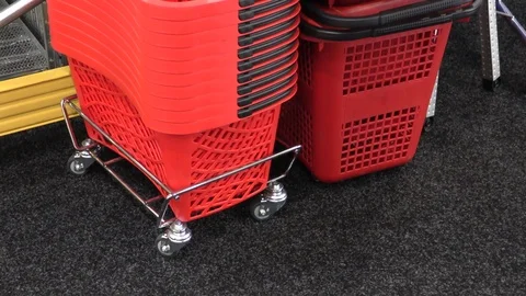Piled up plastic shopping baskets by checkout in supermarket Stock Footage 120308259