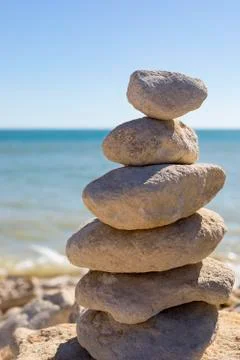 Piled up rocks by the ocean Stock Photos