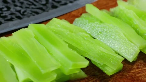 Piled thin slices of lettuce stem stacked together Vidéo 341836490