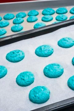 Piles of blue macaroon dough on baking paper Stock Photos